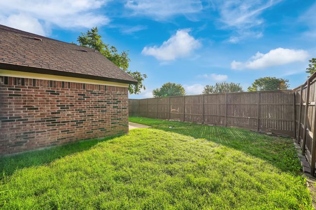 View of fenced backyard | Image 23