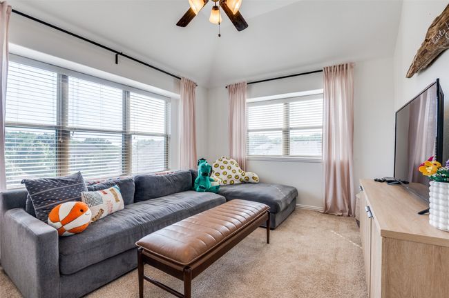 This living room is at the top of the stairs and looks down to the backyard. Great space for the kiddos! | Image 16