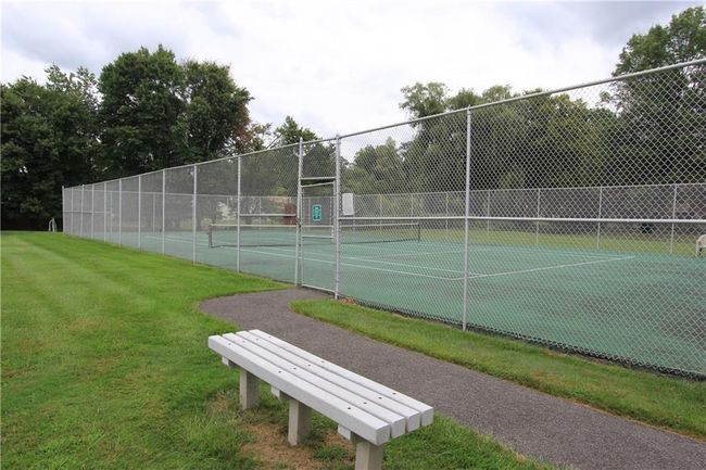 View of tennis court featuring a yard and fence | Image 10