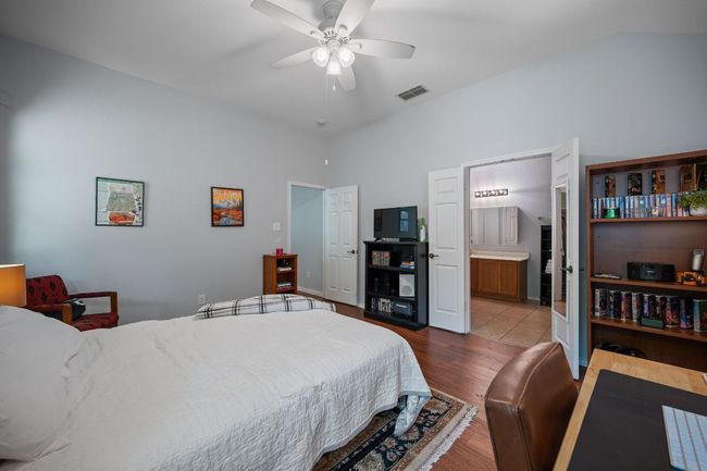 Bedroom with wood finished floors, a ceiling fan, and ensuite bathroom | Image 16
