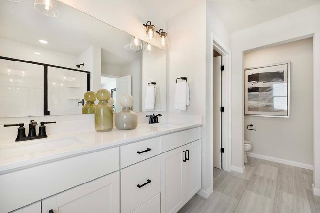 The primary bath is a luxurious and functional space designed for relaxation and convenience. Featuring modern fixtures, a spacious layout, and elegant finishes. Photos are from previously built home; options and features will vary. | Image 21