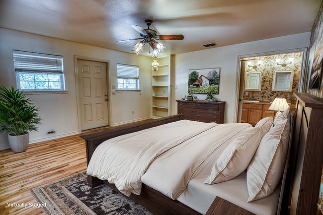 Virtually staged photo of primary bedroom in main house | Image 26