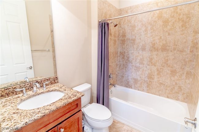 Full bath featuring toilet, shower / bath combo with shower curtain, and vanity | Image 23