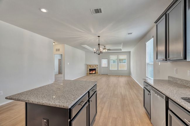 Kitchen with dishwasher, light wood-type flooring, open floor plan, light stone counters, and recessed lighting | Image 12