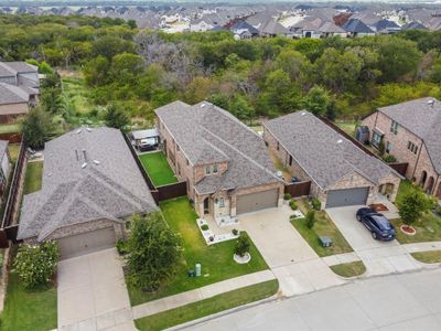 A perfect place for pool parties and relaxation with several covered outdoor living areas, turf side yard and incredible greenbelt views! | Image 1