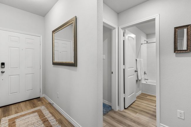 Hall with light wood-style floors and baseboards | Image 10