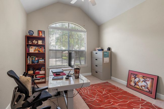 Home office featuring ceiling fan, light colored carpet, and lofted ceiling | Image 25