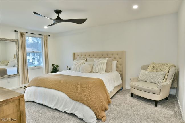 Bedroom with baseboards, recessed lighting, light carpet, and a ceiling fan | Image 25