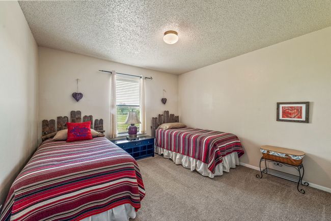Carpeted bedroom featuring baseboards and a textured ceiling | Image 21