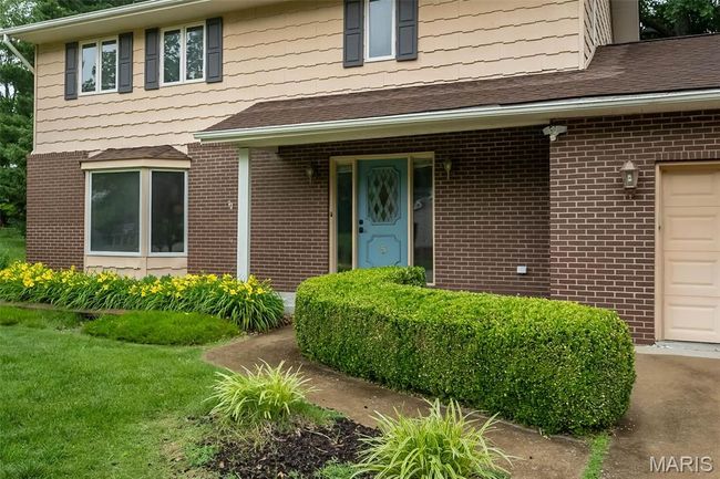 Property entrance featuring brick siding and roof with shingles | Image 4