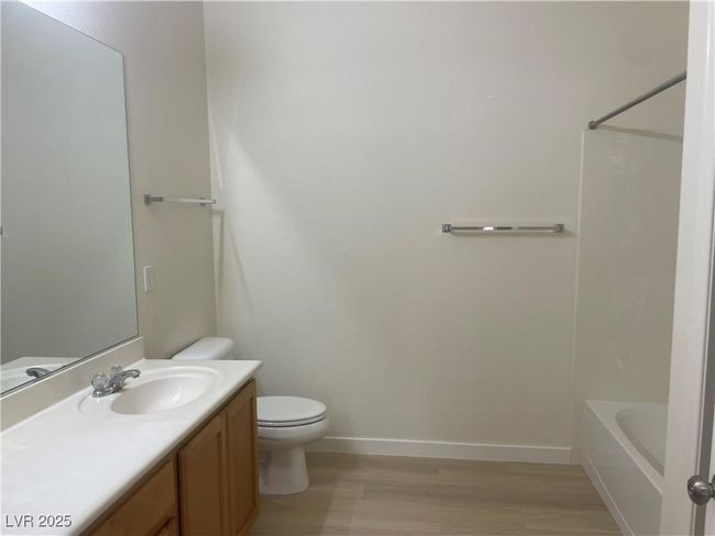 Full bathroom featuring wood finished floors, vanity, and bathtub / shower combination | Image 19
