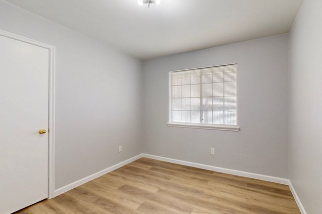 Spare room featuring baseboards and light wood-type flooring | Image 12