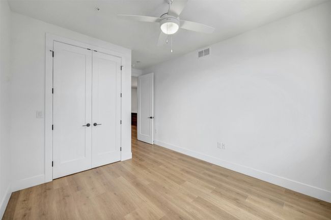Unfurnished bedroom featuring light wood-style floors, a closet, and ceiling fan | Image 17