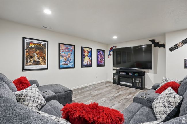 Living area featuring wood finished floors, baseboards, visible vents, and recessed lighting | Image 36