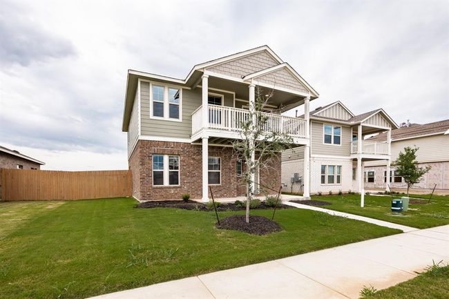 Craftsman-style house featuring a balcony and brick siding | Image 4