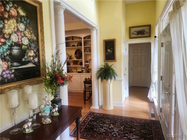 Foyer with plenty of natural light, light wood-style flooring, and ornate columns | Image 9