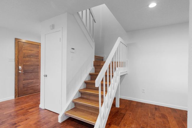 FBedroom featuring wood finished floors, a ceiling fan, and baseboards | Image 16