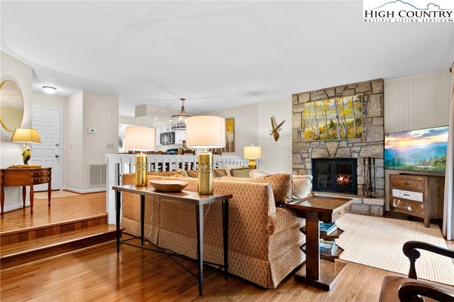 Stone fireplace adds a cozy ambience to ward off the chill | Image 8