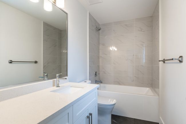 Bathroom with toilet, shower / bathtub combination, and vanity | Image 27