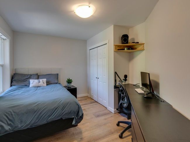 Bedroom with light wood-type flooring, baseboards, and a closet | Image 24