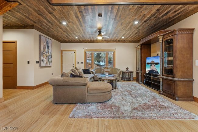 Living area with wooden ceiling, ceiling fan, and wood finished floors | Image 27