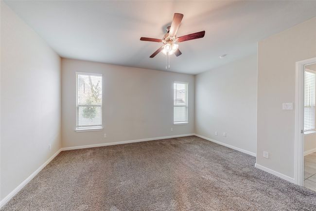 Unfurnished room featuring a ceiling fan, light carpet, and baseboards | Image 14