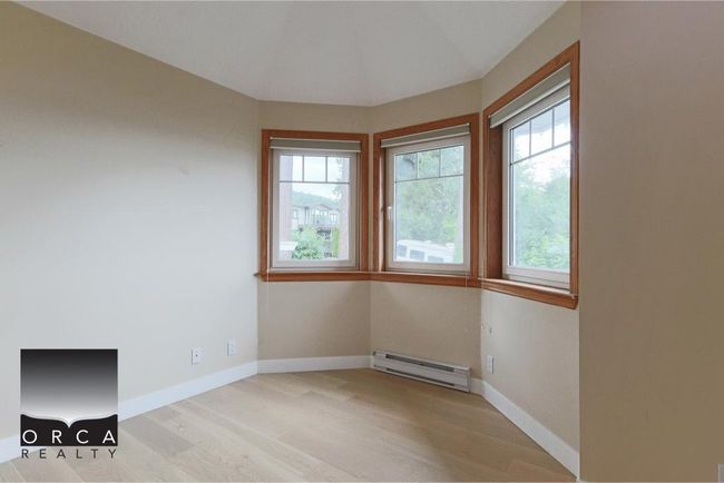Spare room featuring baseboard heating and wood finished floors | Image 27