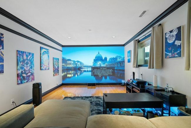 Home theater with wood finished floors, ornamental molding, and recessed lighting | Image 31