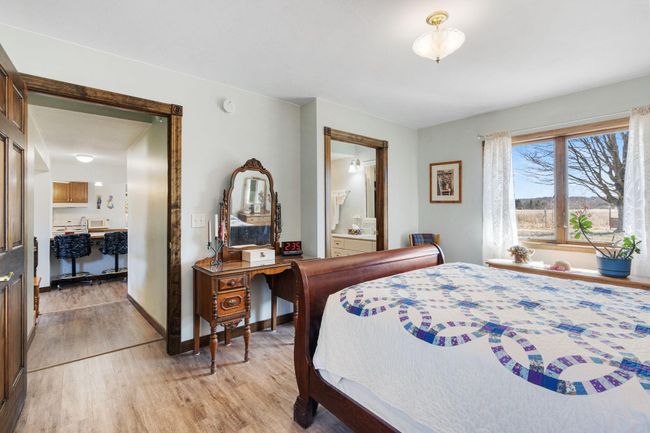 The primary main floor bedroom has a private ensuite 3/4 bath with walk-in closet | Image 11