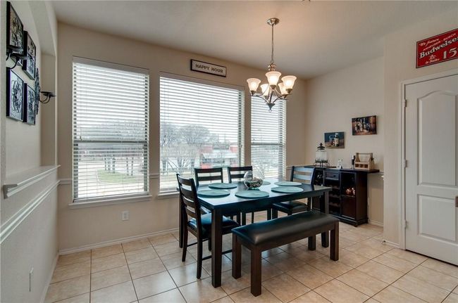 Dining room featuring an inviting chandelier and light tile patterned flooring | Image 9