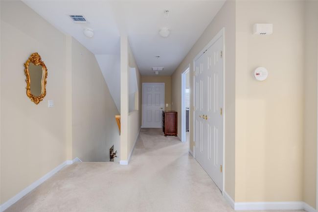 Hall with an upstairs landing and light colored carpet | Image 7