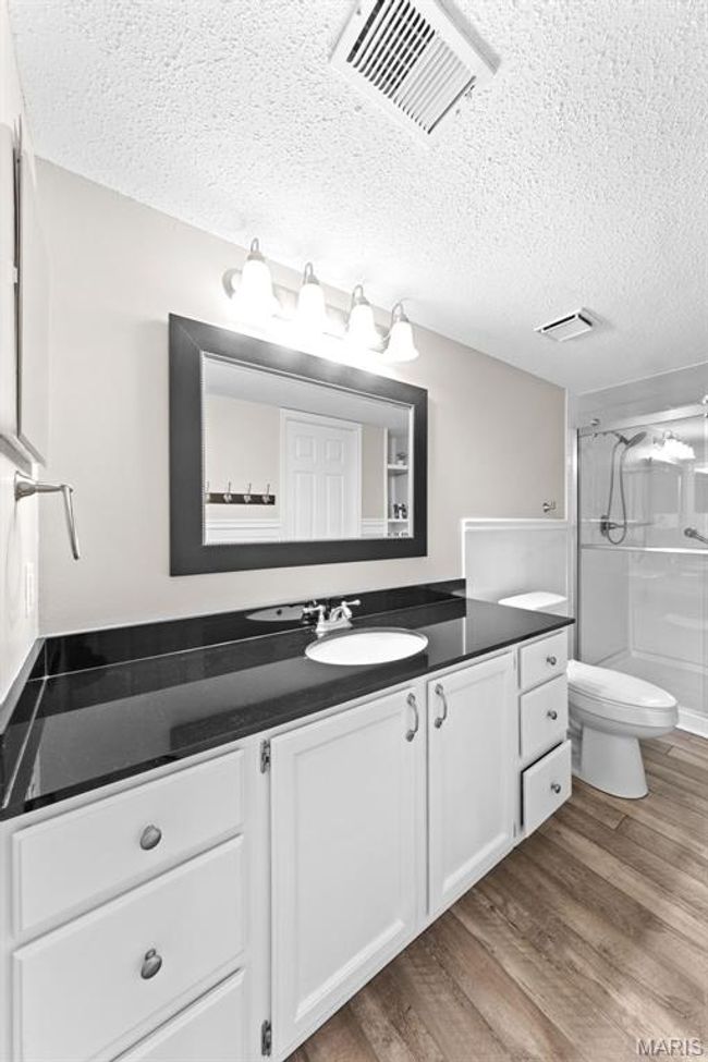 Full bath featuring an oversized vanity, a walk-in shower, tons of storage. | Image 22