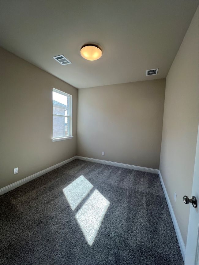 Carpeted spare room with visible vents and baseboards | Image 11