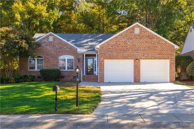 View of front of home with a garage and a front lawn | Image 1