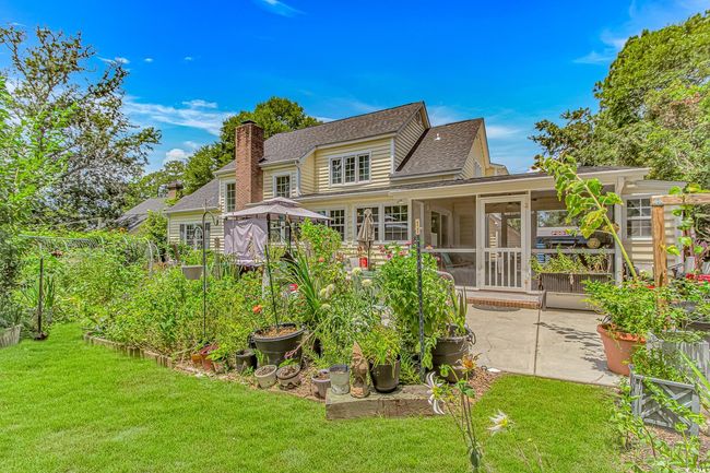 Back of house with a sunroom, a patio area, a shingled roof, a yard, and a chimney | Image 28