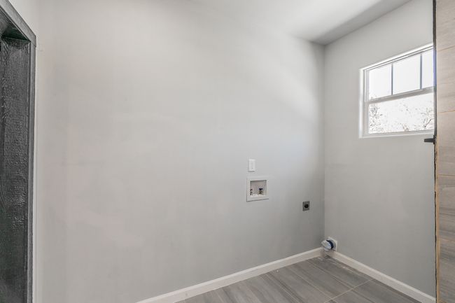 Washroom featuring baseboards, laundry area, hookup for an electric dryer, and hookup for a washing machine | Image 15