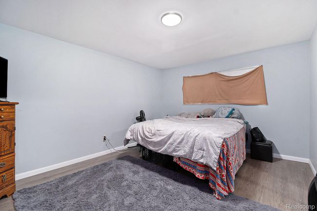 Bedroom featuring baseboards and wood finished floors | Image 12
