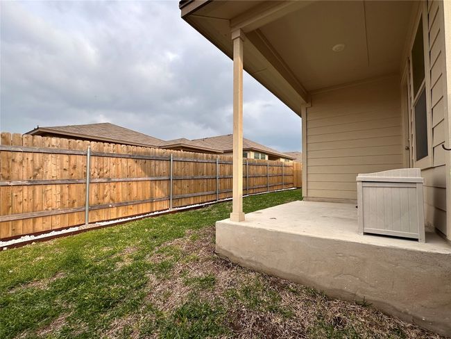 Fenced backyard with a patio | Image 36