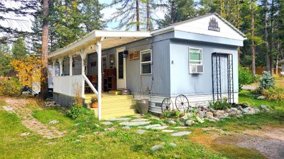 View of outbuilding featuring cooling unit and a porch | Image 2