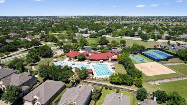 Drone / aerial view of community a pool area, clubhouse, tennis courts, basketball courts and volleyball court. | Image 35