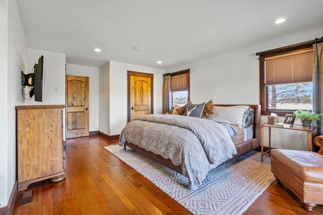 Bedroom featuring dark wood-style floors, visible vents, and recessed lighting | Image 38