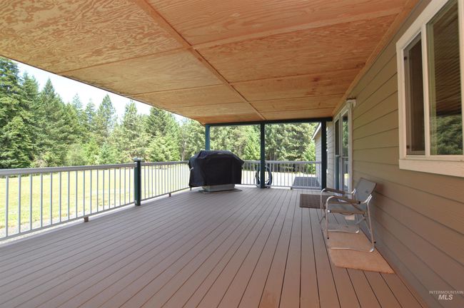 Wooden terrace featuring a grill | Image 4