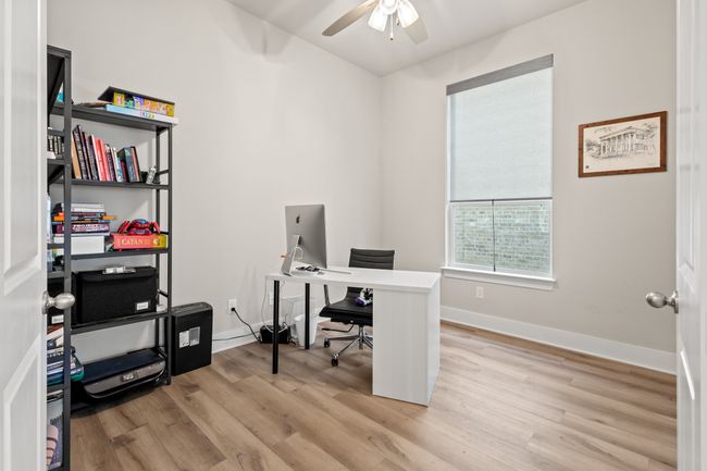 Office featuring light wood-type flooring, baseboards, and ceiling fan | Image 24