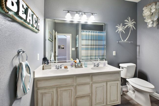 Full bathroom featuring double vanity and curtained shower | Image 24