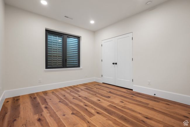 Unfurnished bedroom featuring wood finished floors and recessed lighting | Image 60