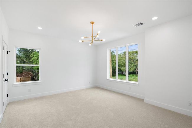 This bedroom offers spa-like bathroom and walk-in custom closet | Image 24