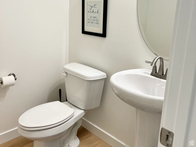 1/2 Bathroom featuring toilet and wood finished floors | Image 9