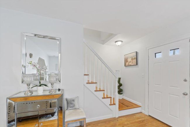 Foyer entrance featuring stairs, wood finished floors, and baseboards | Image 23