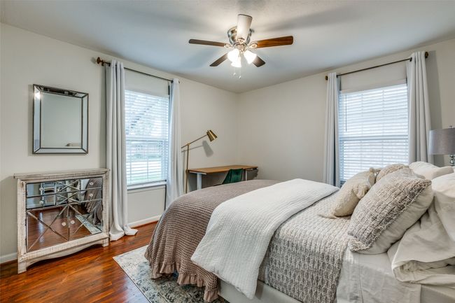 Bedroom with wood-type flooring and ceiling fan | Image 24