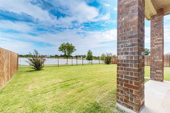 Fenced backyard featuring a water view | Image 36